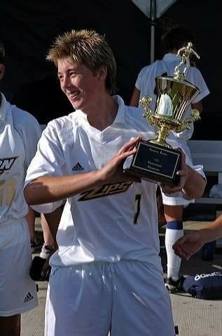 Holding a Trophy when playing for the Akron Zips